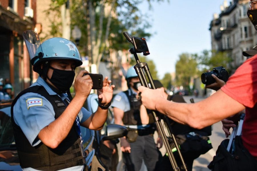 Protesters interact with members of the Chicago Police Department. 