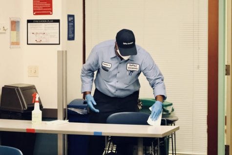 A Facility Operations employee disinfects a classroom as part of new regulations designed to prevent the spread of COVID-19.