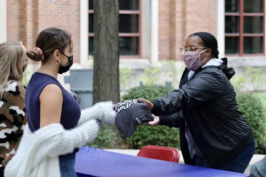 Students receive their free T-Shirt by St. Vincent’s Circle as part of one of the few in-person events for Welcome a Week at DePaul University.