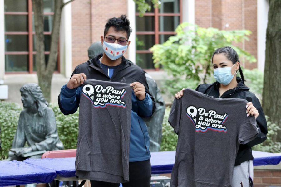 DePaul students hold up their free t-shirts received at one of the few in-person welcome week events on campus.