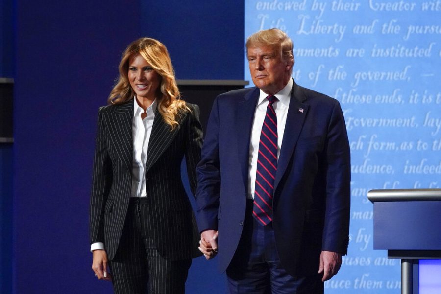 In this Sept. 29, 2020, file photo, President Donald Trump and first lady Melania Trump hold hands on stage after the first presidential debate at Case Western University and Cleveland Clinic, in Cleveland, Ohio. President Trump and first lady Melania Trump have tested positive for the coronavirus, the president tweeted early Friday. (AP Photo/Julio Cortez, File)