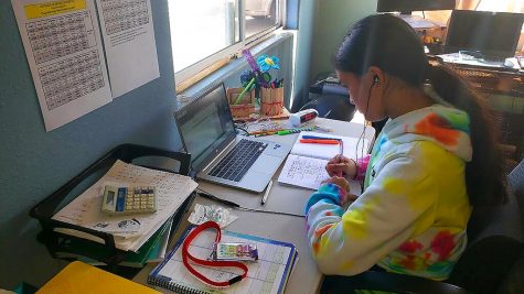 This photo provided by Charles Timtim shows his daughter, name withheld by parents, doing schoolwork from home in Waipahu, Hawaii, Tuesday, Sept. 22, 2020. Timtim's mother doesn't think it's safe for her daughter to be back at school but she also doesn't want her exposed to an online learning program called Acellus that misspelled and mispronounced the last queen to rule the Hawaiian kingdom. Parents spotting questionable content on Acellus is forcing some school districts across the country to reconsider the program or stop using it. (Charles Timtim via AP)