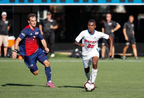 DePaul junior midfielder Patrick Watkins dribbles the ball past a UIC defender in 2019.