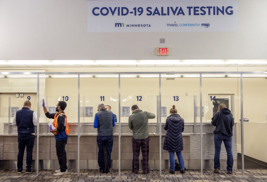 FILE - In this Nov. 12, 2020, file photo, people get tested at the new saliva COVID-19 testing site at the Minneapolis-St. Paul International Airport. With the coronavirus surging out of control, the nation’s top public health agency advised Americans on Thursday, Nov. 19, not to travel for Thanksgiving and not to spend the holiday with people from outside their household. (Elizabeth Flores/Star Tribune via AP, File)
