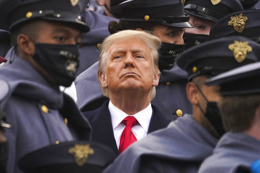 Surrounded by Army cadets, President Donald Trump watches the first half of the 121st Army-Navy Football Game in Michie Stadium at the United States Military Academy, Saturday, Dec. 12, 2020, in West Point, N.Y. (AP Photo/Andrew Harnik)