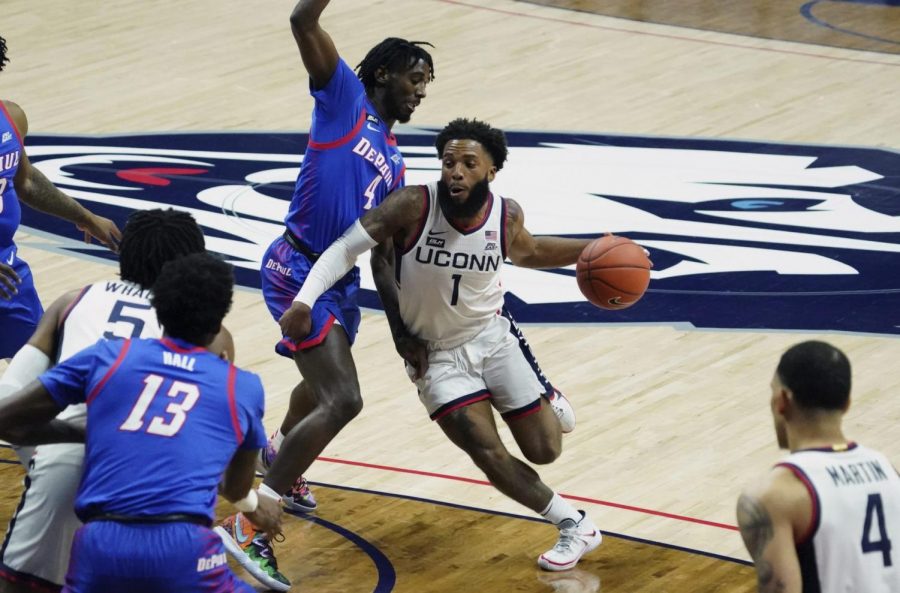 Connecticut guard R.J. Cole (1) drives the ball against DePaul guard Javon Freeman-Liberty (4) during the first half of an NCAA college basketball game Wednesday, Dec. 30, 2020, in Storrs, Conn. 