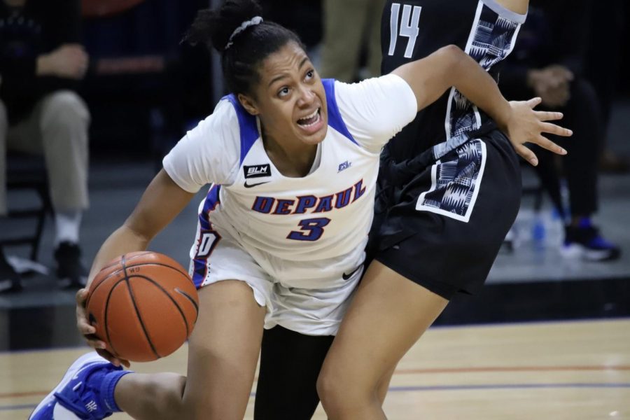 DePaul senior guard Deja Church looks to go around a Georgetown defender on Saturday at Wintrust Arena.