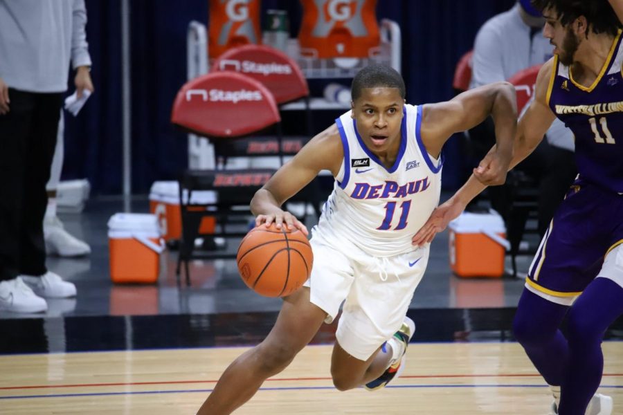 DePaul senior guard Charlie Moore looks to drive past a Western Illinois defender on Wednesday at Wintrust Arena.