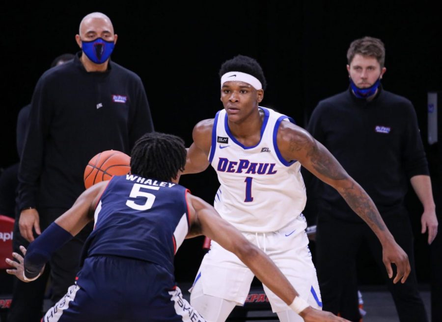 DePaul sophomore forward Romeo Weems stands in front of a UConn player on Monday at Wintrust Arena.