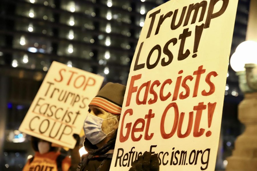 Signs targeting President Trump at a gathering outside Trump Tower held by Refuse Fascism. 