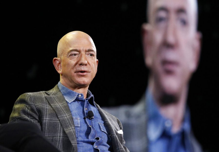 FILE - In this June 6, 2019, file photo Amazon CEO Jeff Bezos speaks at the the Amazon re:MARS convention in Las Vegas. Washington states richest residents, including Bezos and Bill Gates, would pay a wealth tax on certain financial assets worth more than $1 billion under a proposed bill whose sponsor says she is seeking a fair and equitable tax code. Under the bill, starting Jan. 1, 2022, for taxes due in 2023, a 1% tax would be levied on extraordinary assets ranging from cash, publicly traded options, futures contracts, and stocks and bonds. (AP Photo/John Locher, File)