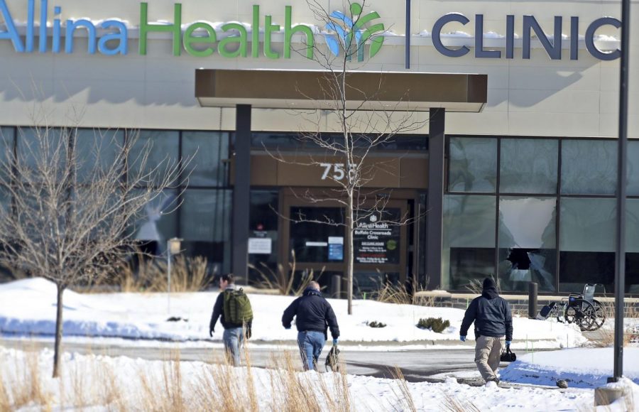  In this Tuesday, Feb. 9, 2021 file photo, law enforcement personnel walk toward the Allina Health clinic where multiple people were shot in Buffalo, Minn. Doctors say theyre facing increasing threats of violence for refusing to prescribe opioids or trying to wean patients off the addictive painkillers. The issue was underscored by Tuesdays shooting at the Minnesota clinic.