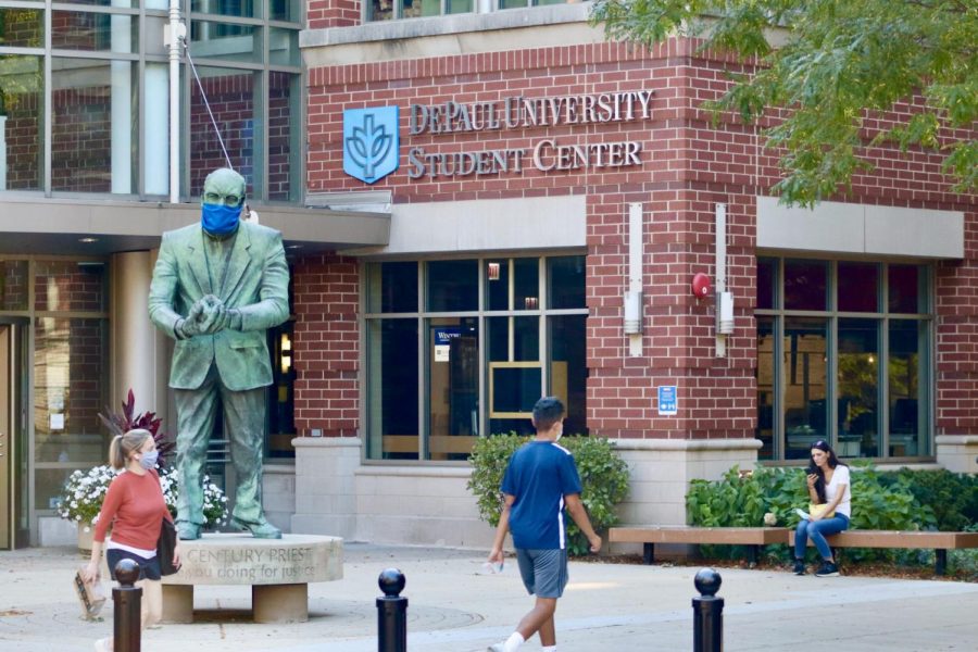 Students walk around a mostly empty campus during the pandemic. 