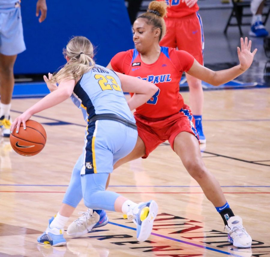 DePaul senior guard Deja Church defends a Marquette player on Wednesday at Wintrust Arena.