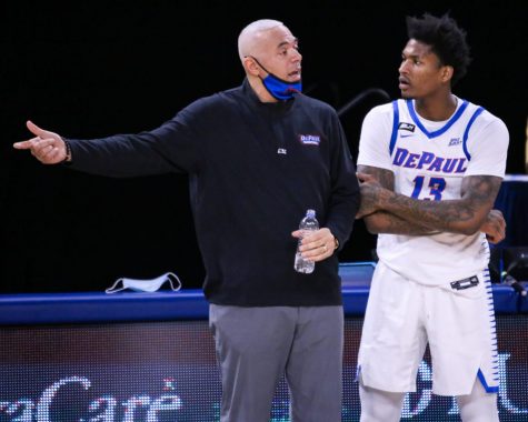 DePaul mens basketball head coach Dave Leitao talks to junior forward Darious Hall during the Blue Demons game against Georgetown on Saturday at Wintrust Arena.