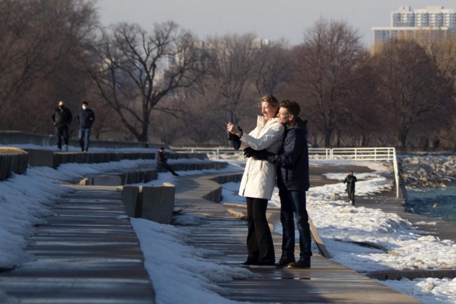 A man and woman pose for a selfie on the Lakefront Trail
