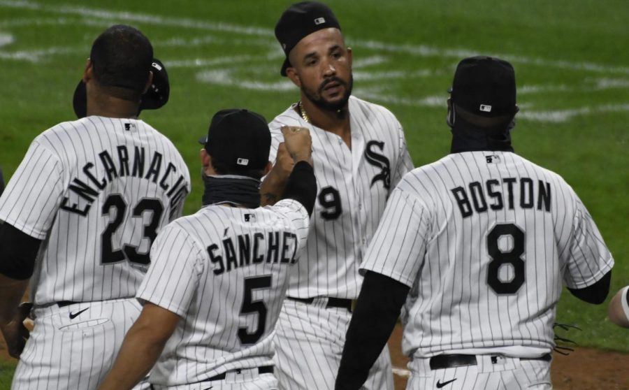 : Chicago White Sox first baseman Jose Abreu, center, celebrates with his teammates after they defeated the Detroit Tigers in a baseball game, Saturday, Sept.12, 2020, in Chicago.