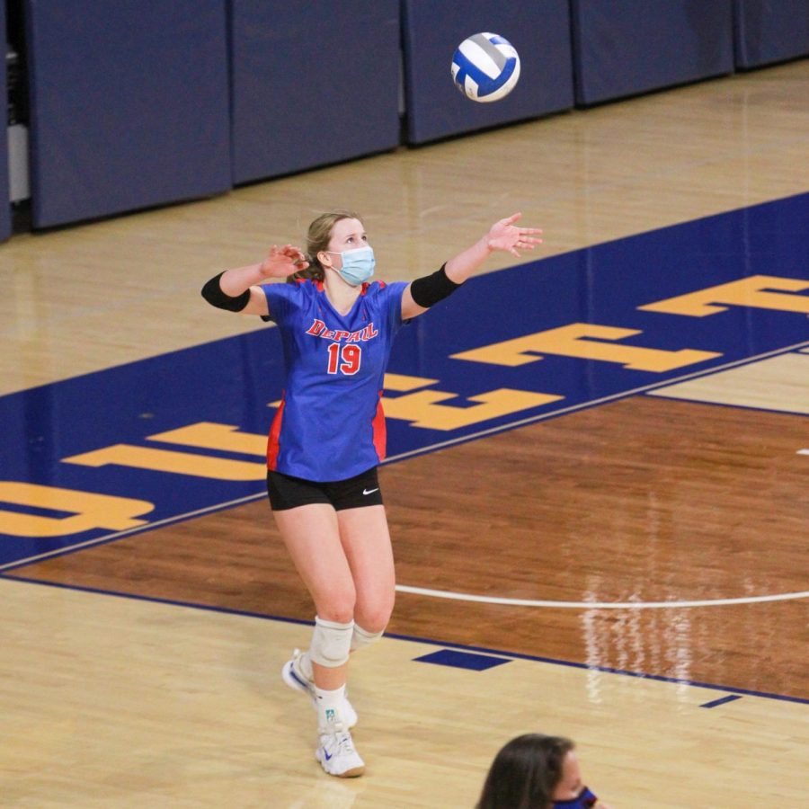 DePaul freshman Hanna Karl goes to serve the ball in the Blue Demons match against Marquette.
