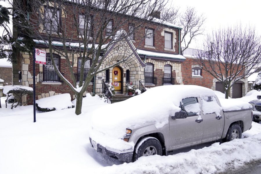 A snow covered truck sits outside the home of former Illinois House Speaker Michael Madigan Thursday, Feb. 18, 2021, near Midway International Airport in Chicago. Madigan announced his resignation from the Illinois House Thursday, after representing a Southwest Side Chicago area district for a half-century. (AP Photo/Charles Rex Arbogast)