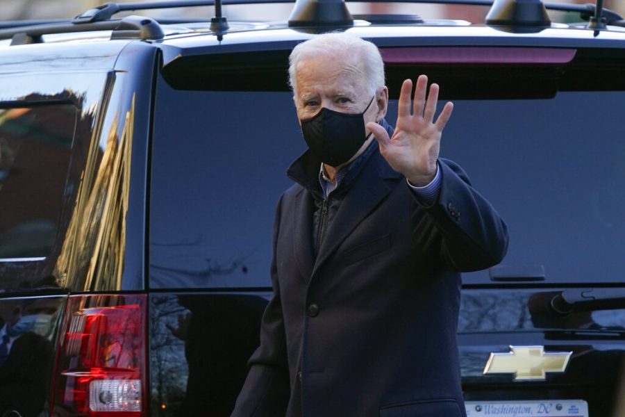 President Joe Biden waves as he arrives for Mass at Holy Trinity Catholic Church in the Georgetown neighborhood of Washington, Saturday, March 6, 2021. (AP Photo/Patrick Semansky)