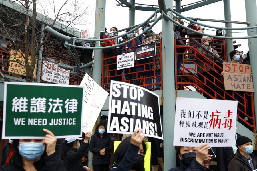 Demonstrators holding signs take part in a rally against Asian hate crimes, Saturday, March 27, 2021 at Chinatown in Chicago. The gathered crowd demanded justice for the victims of the Atlanta spa shooting and for an end to racism, xenophobia and misogyny. (AP Photo/Shafkat Anowar)