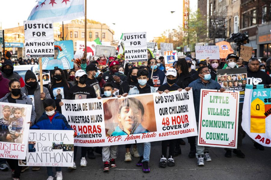 Protesters march near Mayor Lori Lightfoots home in Logan Square to protest the fatal shooting by Chicago police of 13-year-old Adam Toledo, Friday, April 16, 2021.  Video of last months encounter was released Thursday and provoked an outpouring of grief and outrage. (Ashlee Rezin Garcia/Chicago Sun-Times via AP)