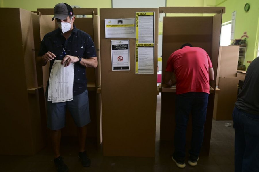 Voters use booths to mark their ballots for the general election at a polling center set up at the Rafael Labra School in San Juan, Puerto Rico, Tuesday, Nov. 3, 2020. (AP Photo/Carlos Giusti)
