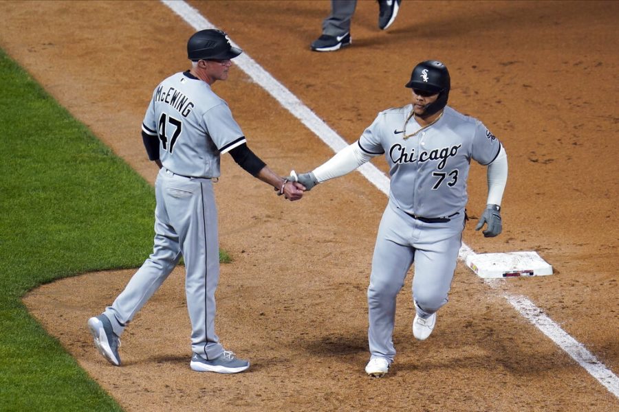 Chicago White Soxs Yermin Mercedes, right, is congratulated by third base coach Joe McEwing after his home run off Minnesota Twins Willians Astudillo in the ninth inning of a baseball game, Monday, May 17, 2021, in Minneapolis. (AP Photo/Jim Mone)