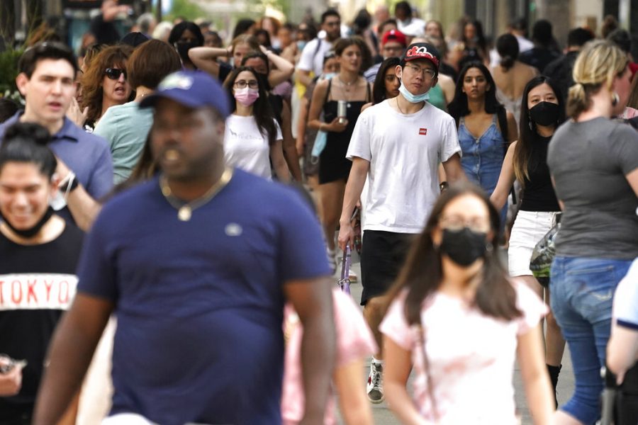 Pedestrians walk along a shopping district on Michigan Avenue in downtown Chicago on Saturday, May 22, 2021. Chicago will no longer require masks for fully vaccinated people in most settings following similar changes from the state of Illinois and new guidance from the U.S. Centers for Disease Control and Prevention. (AP Photo/Nam Y. Huh)