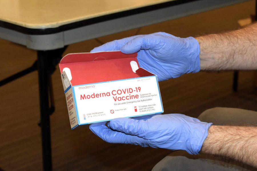 A Michigan Avenue Immediate Care employee holding a box of Moderna vaccines at DePauls vaccine clinic April 29.