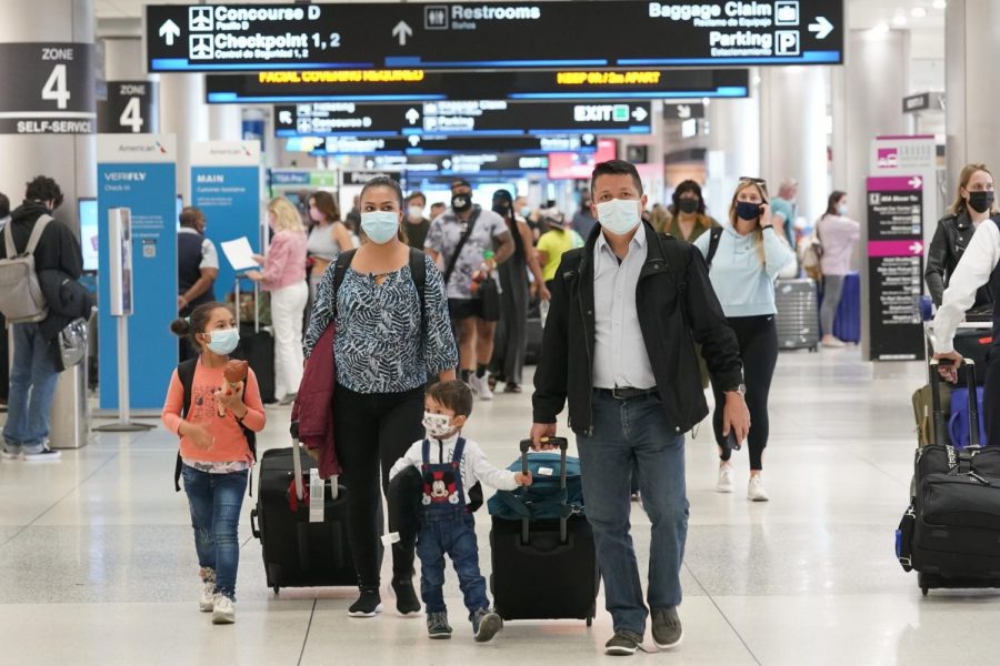 Henry Hernandez, his wife Karina Gonzalez and their children Jose Sebastian, 2, and Laura, 6, of Colombia, walk towards the baggage claim area at Miami International Airport, Friday, May 28, 2021, in Miami. The couple were surprised to be offered the Johnson & Johnson COVID-19 vaccine upon arrival to the U.S. It is their first overseas trip since the pandemic began last year. Floridas Emergency Management Agency is running the program through Sunday.