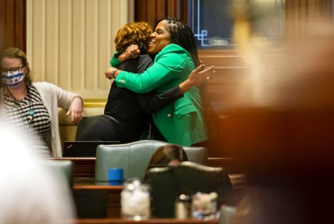 Illinois State Rep. Jehan Gordon-Booth, D-Peoria, right, hugs Illinois State Rep. Camille Lilly, D-Chicago, as they celebrate the passage of Senate Bill 818, the bill to update sex education standards in Illinois,on the floor of the Illinois House of Representatives at the Illinois State Capitol in Springfield, Ill., Friday, May 28, 2021. (Justin L. Fowler/The State Journal-Register via AP)