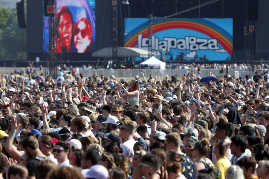  In this July 29, 2021 file photo, fans gather and cheer on day one of the Lollapalooza music festival at Grant Park in Chicago. (Shafkat Anowar/Associated Press)