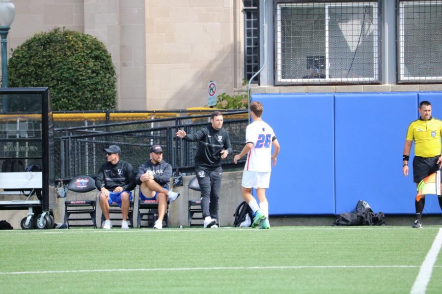 DePaul men's soccer coach Mark Plotkin talking to a player during their game against UConn on Sept 25. 