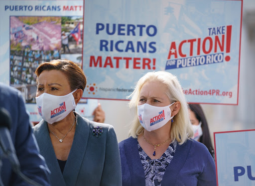 Rep. Nydia Velazquez, left, and Sen. Kirsten Gillibrand join advocates for Puerto Rico at the Capitol in Washington on Sept. 20.