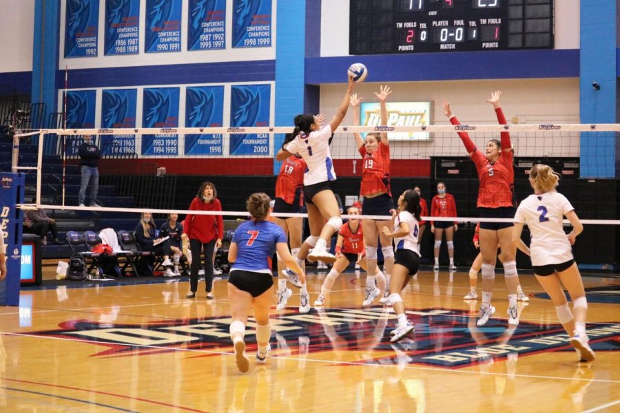 DePaul+middle+blocker+Donna+Brown+tipping+the+ball+over+St.+Johns+blockers+on+Saturday.+