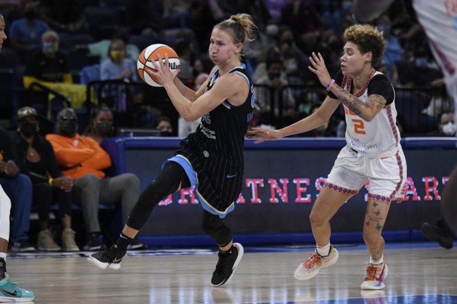 Chicago Skys Courtney Vandersloot (22) drives against Connecticut Suns Natisha Hiedeman (2) during the second half of Game 3 of a WNBA semifinal playoff basketball game Sunday, Oct. 3, 2021, in Chicago. Chicago won 86-83