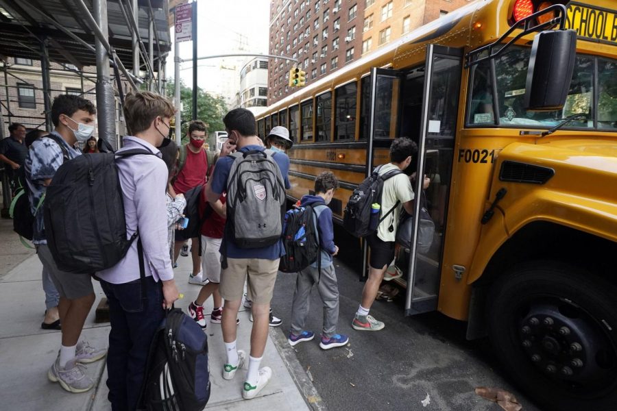 Students+board+a+school+bus+on+New+Yorks+Upper+West+side%2C+pandemic+disruptions+remain+inevitable+as+students+return+in-person.+%28Richard+Drew+%7C+Associated+Press%29