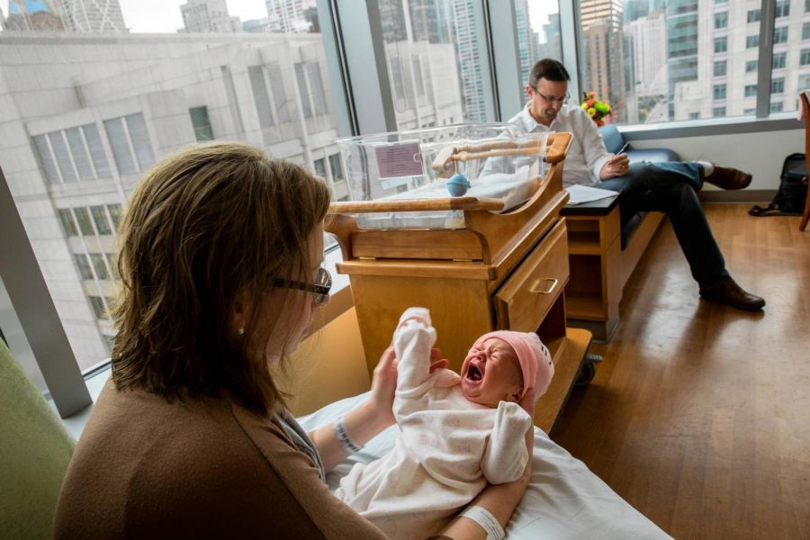 Katie Bambacht holds her 2-day-old daughter, Evie, in a room with her husband, Zachary, in Prentice Womens Hospital in Chicago. (Zbigniew Bzdak/Tribune Photo)