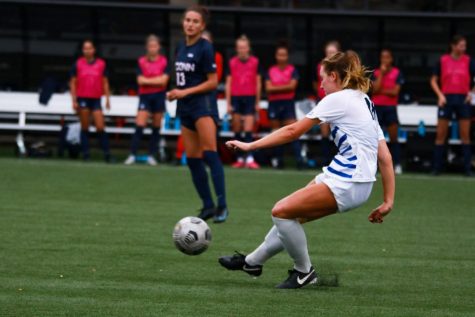 Defender Megan Malecha kicking the ball away during their game against UConn. 