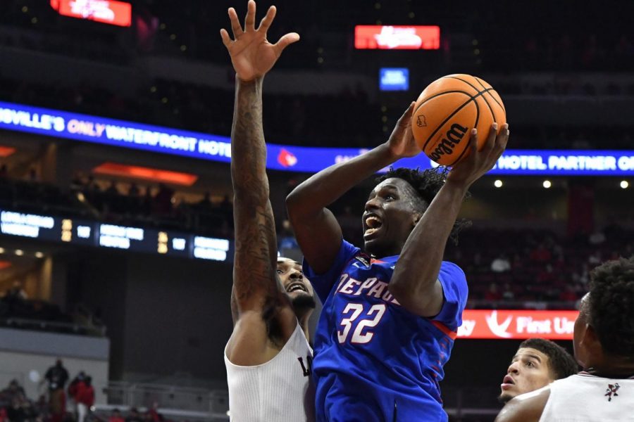 DePaul forward David Jones (32) shoots next to Louisville forward Malik Williams during the first half of an NCAA college basketball game in Louisville, Ky., Friday, Dec. 10, 2021.