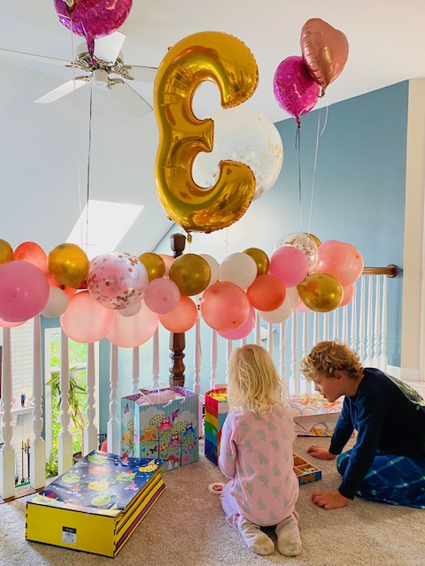 Lawler decorated her daughters birthday party with balloons gifted from the Buy Nothing group, including a reused three balloon that would be passed around the group to help celebrate three different birthdays in total.