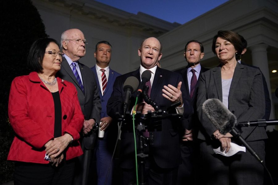 PATRICK SEMANSKY | AP PHOTO
Sen. Chris Coons, D-Del., center, speaks with reporters to discuss the upcoming Supreme Court vacancy, Feb. 10, 2022, at the White House.