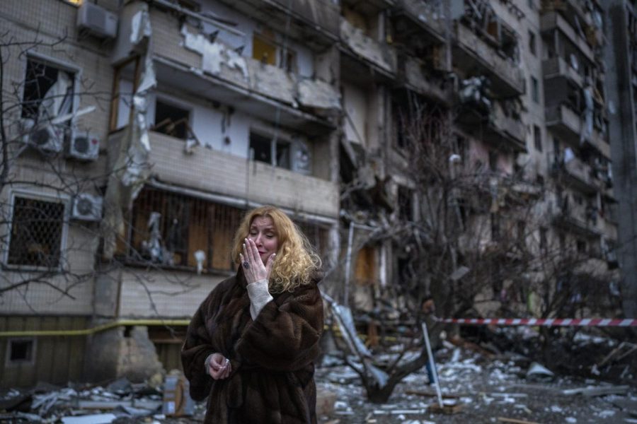 Natali Sevriukova reacts next to her house following a rocket attack the city of Kyiv, Ukraine, Friday, Feb. 25, 2022