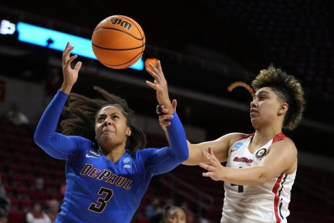 DePaul guard Deja Church (3) is fouled by Dayton guard Capria Brown, right, during the first half of a First Four game in the NCAA college basketball tournament, Wednesday, March 16, 2022, in Ames, Iowa
