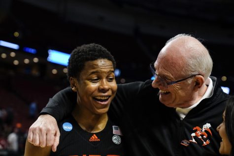 Miamis Charlie Moore, left, celebrates with Miami head coach Jim Larranaga, right, after a win over Auburn in a college basketball game in the second round of the NCAA tournament Sunday, March 20, 2022, in Greenville, S.C.