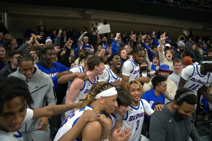 Players celebrating with fans after DePauls 90-81 win over Marquette on March 2, 2022. 