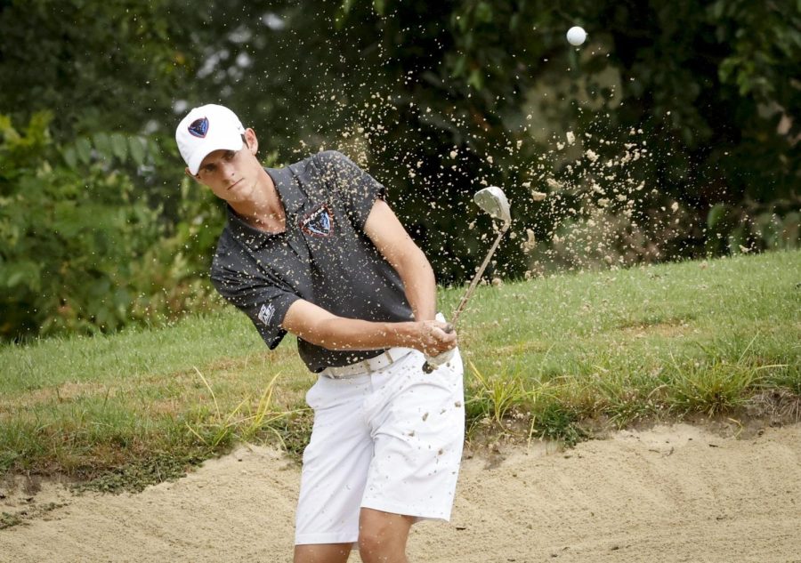 David Griggs swings out of a sand bunker. 