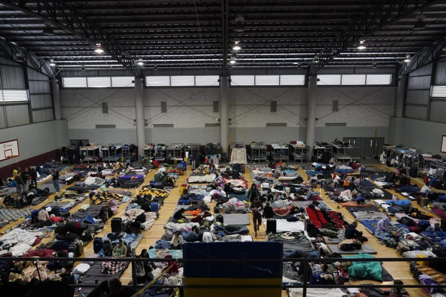 Ukrainian refugees wait in a gymnasium Tuesday, April 5, 2022, in Tijuana, Mexico. Hundreds of Ukrainian refugees are arriving daily to this Mexican border city, where they wait two to four days for U.S officials to admit them on humanitarian parole. (AP Photo/Gregory Bull)