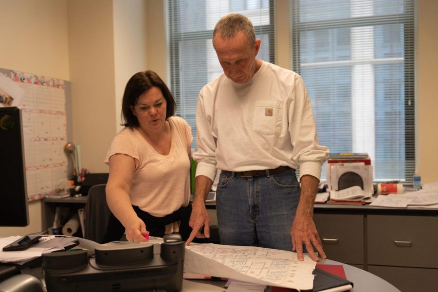 Construction Project manager Katrina Ladendorf [left] discusses plans for the twelfth floor of the Daley building with Vice President of Facility Operation President Bob Janis [right].